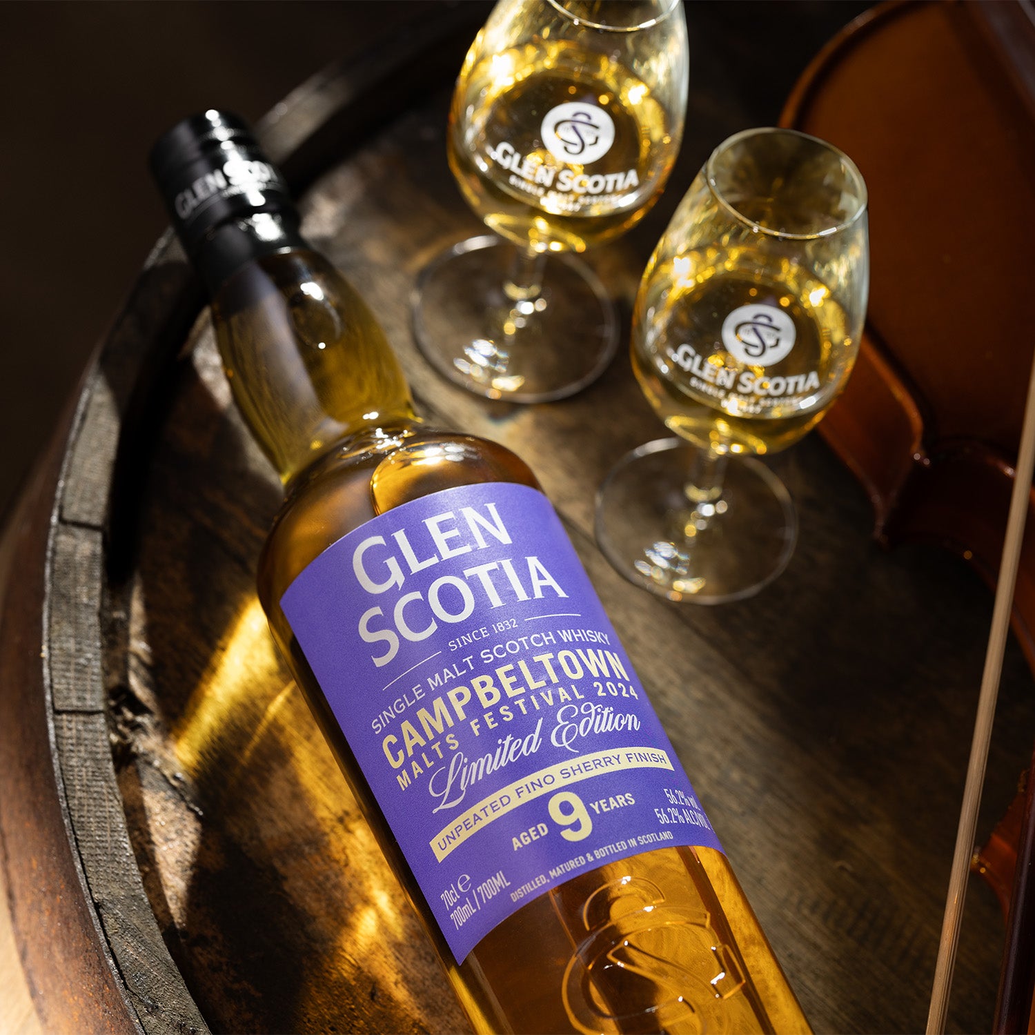 Image of a bottle of Glen Scotia Single Malt Scotch Whisky next to its box. The box and label display "Campbeltown Malts Festival 2024 Limited Edition" and highlight the whisky's age of 9 years. The clear bottle showcases the amber-colored spirit within, emphasizing its limited-edition bottling appeal.