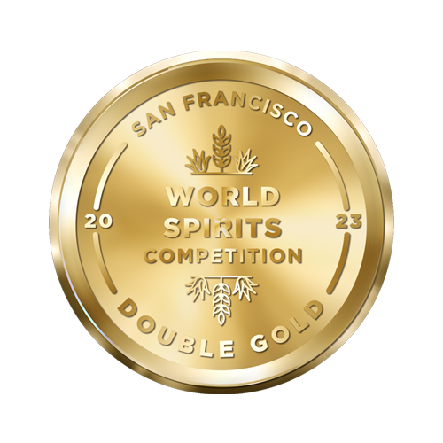 A gold medallion with the text "San Francisco World Spirits Competition" and "Double Gold 2023" embossed on it. The medallion features a decorative emblem in the center, surrounded by the year "2023" split on either side.