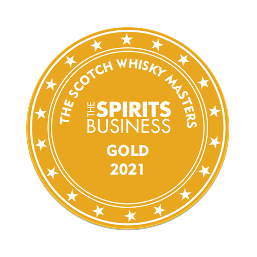 A circular gold medal with white text and stars around the border. The text reads "The Spirits Business The Scotch Whisky Masters Gold 2021.