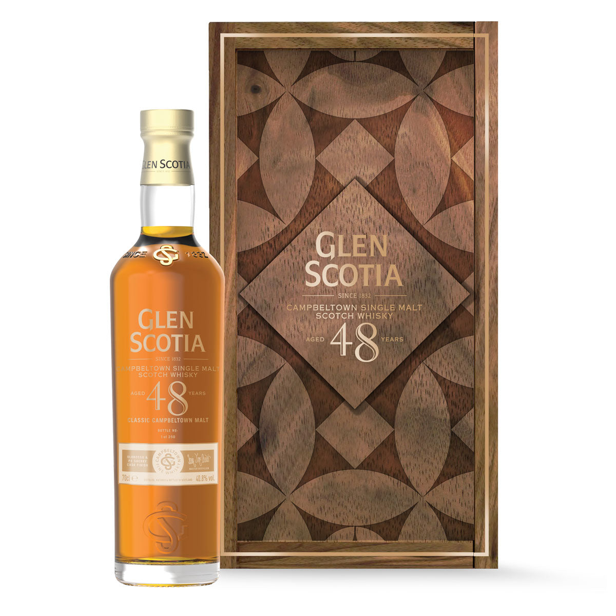 A bottle of Glen Scotia Old & Rare 48 Year Old Whisky is displayed in an elegant wooden case adorned with intricate geometric designs. The open case reveals the gold-hued bottle standing upright against a black background.