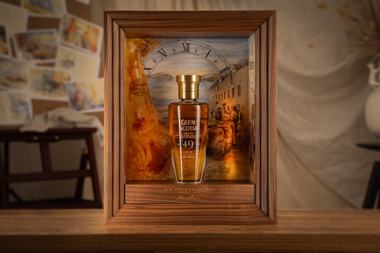 A well-lit image of a Glen Scotia 49-year-old single malt Scotch whisky bottle. The whisky is encased in a wooden frame with an artistic background depicting a clock and painting. The bottle has a gold cap and label, emphasizing its premium quality.