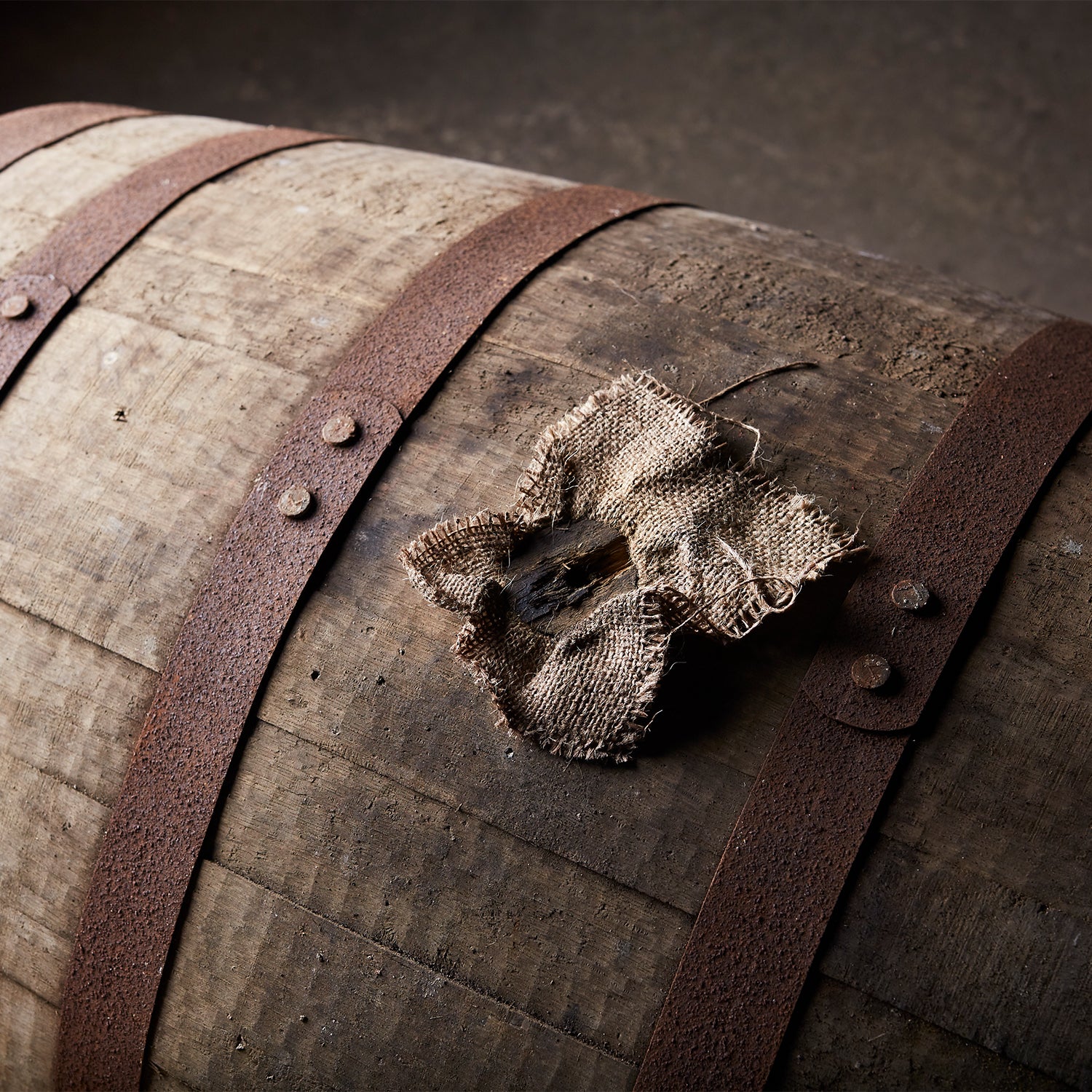 A wooden barrel with a flower on it.