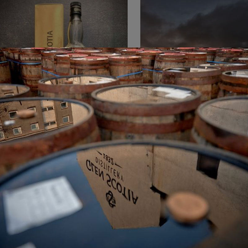 A collection of wooden barrels, some with labels, are arranged closely together in a warehouse setting. In the background, a bottle and a box are placed on a shelf. A reflection of a distillery with text can be seen on one of the barrels. A cloudy sky looms outside.