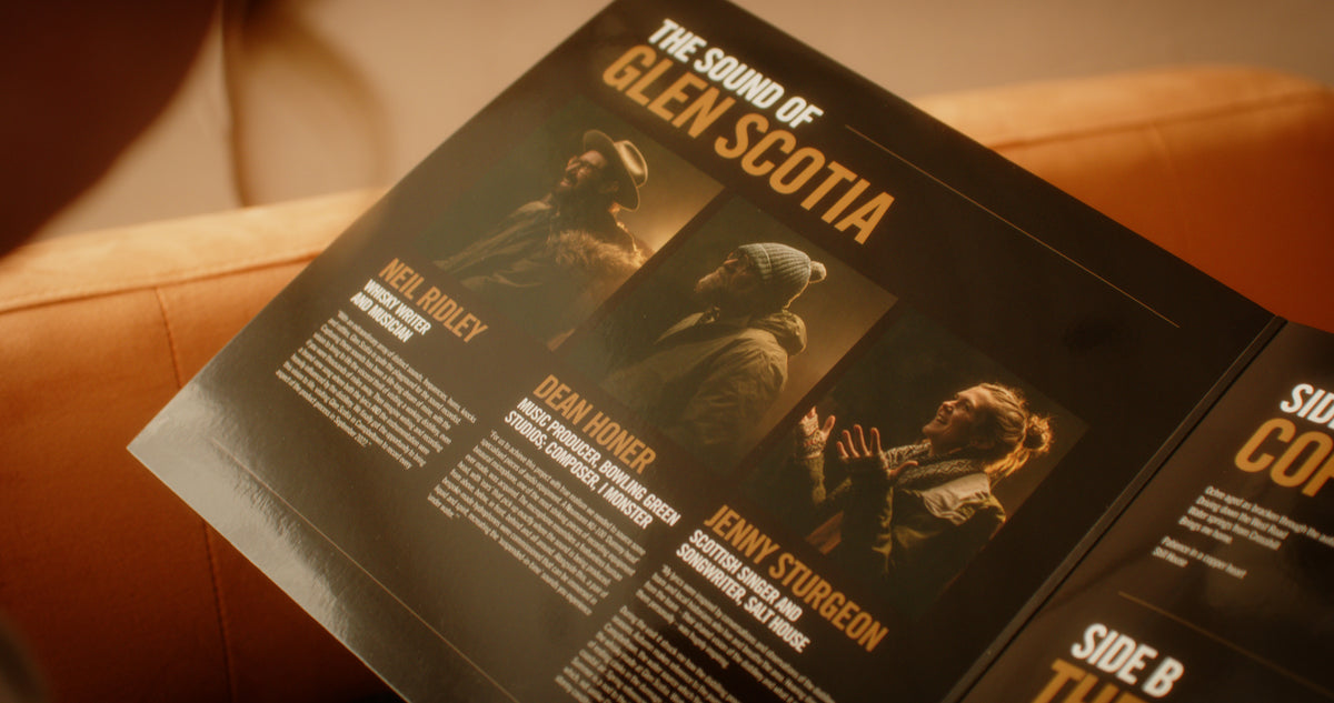 A person is holding an open booklet titled &quot;The Sound of Glen Scotia&quot; by the brand Glen Scotia. The booklet, dedicated to the renowned Campbeltown whisky, displays three profiles complete with images and descriptions: Neil Ridley, Dean Honer, and Jenny Sturgeon. To the right, there are partial glimpses of entries for Side B and Side C.