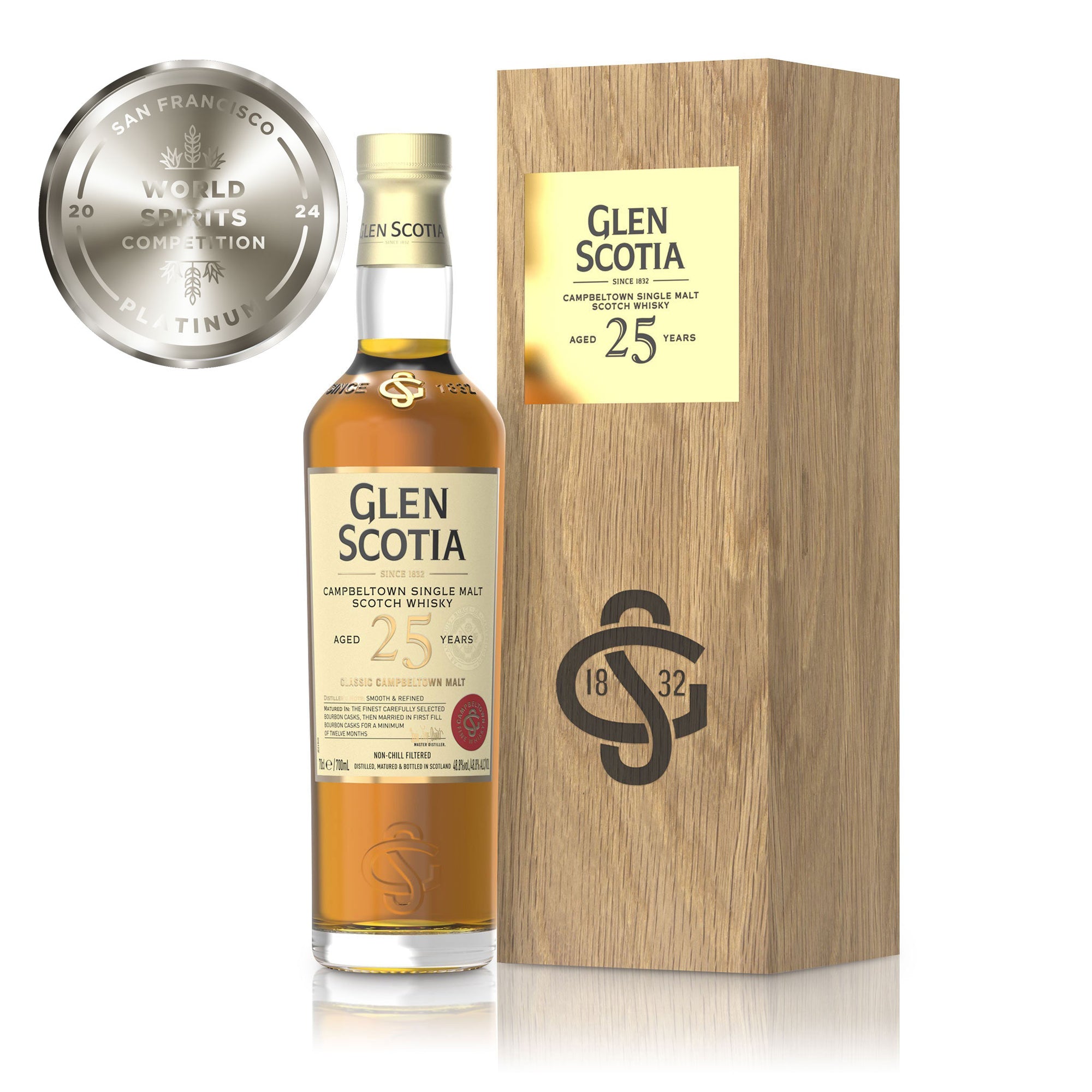 Photo of a Glen Scotia 25 Year Old Single Malt Scotch Whisky bottle positioned next to a wooden box. The bottle's label includes information about the whisky's age and origin. To the left of the image, a silver "World Spirits Competition 2024 Platinum" medal is prominently shown, making it a perfect option for whisky gifts.