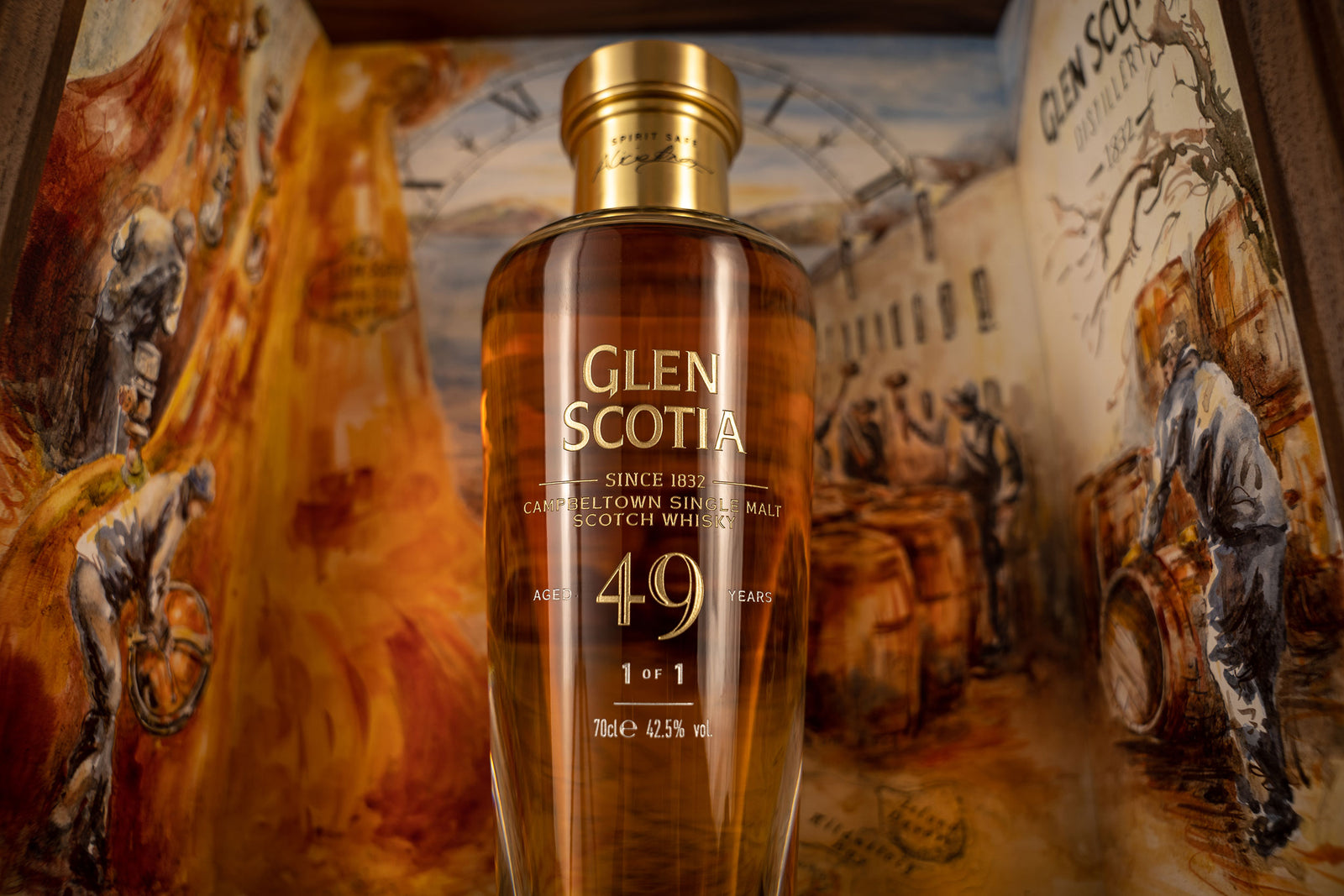 A bottle of Glen Scotia 49-year-old single malt Scotch whisky. The bottle is displayed against a backdrop featuring painted scenes of distillation and whisky barrels. The label on the bottle reads "Glen Scotia" and "49 years.
