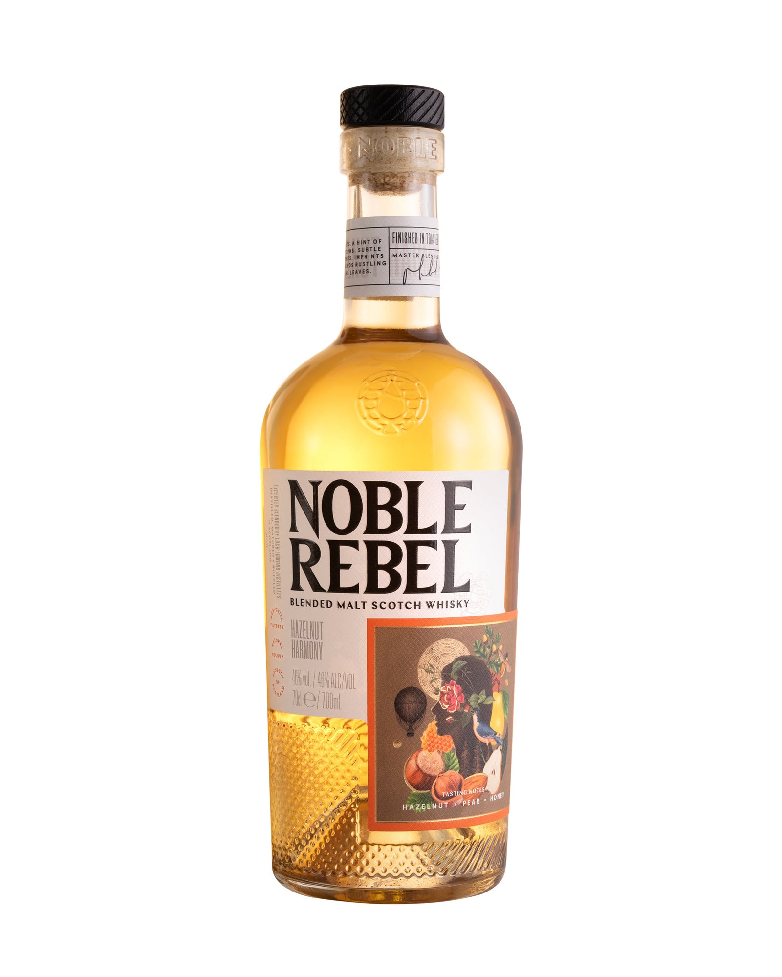 A bottle of Noble Rebel Whisky - Hazelnut Harmony is placed next to its corresponding box. The bottle has a golden whisky inside, with a label featuring colorful artwork. The white box displays "Noble Rebel" along with product details in bold letters, making it an ideal whisky gift for enthusiasts.