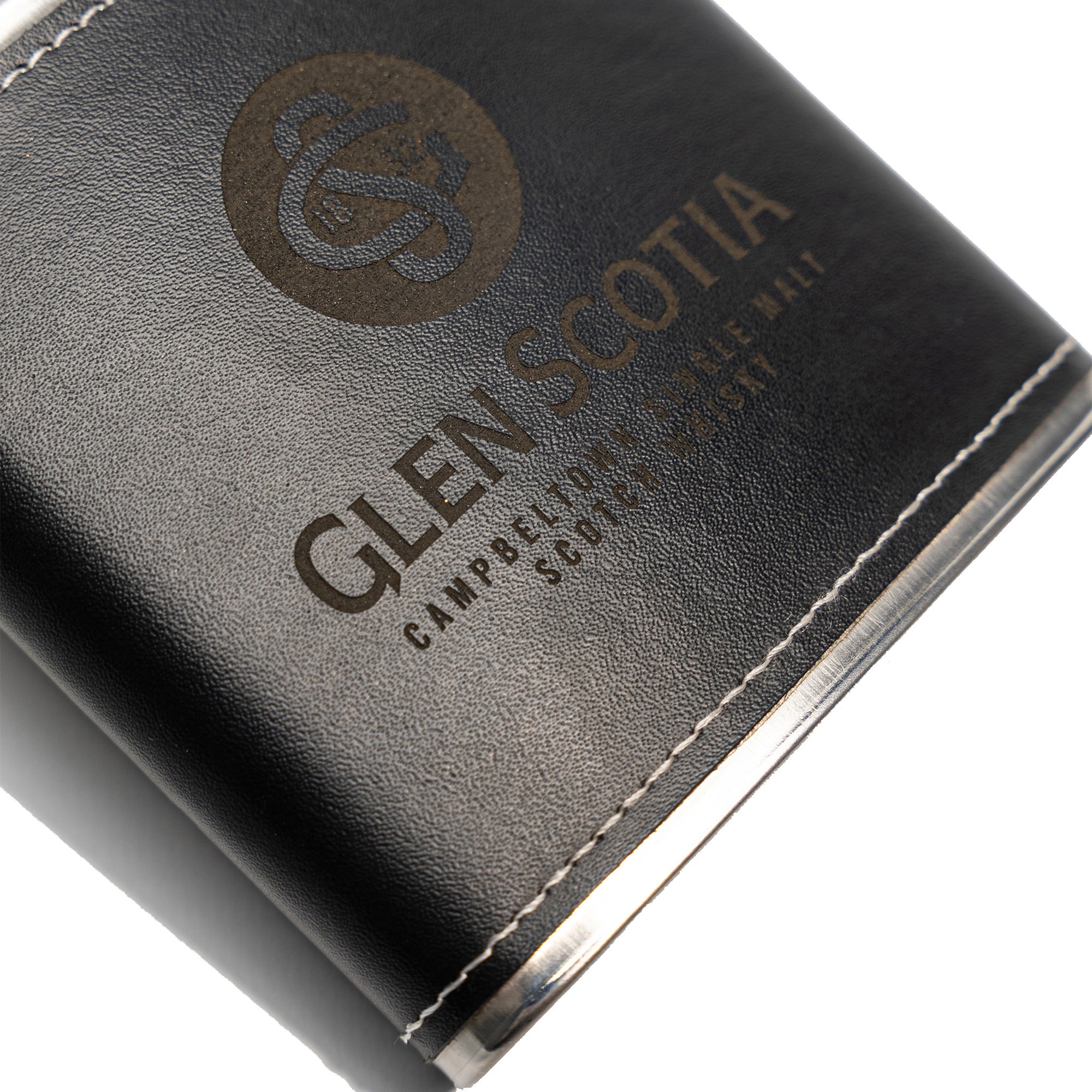 Introducing the Glen Scotia Whisky Hipflask, a sleek black leather-wrapped metal flask featuring a screw cap and embossed with the gold logo and text "Glen Scotia Campbeltown Single Malt Scotch Whisky." Ideal for whisky enthusiasts, this flask is designed with elegant white stitching along the top and bottom edges.